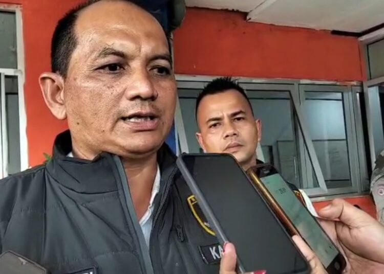 Kepala Satuan Reskrim Polres Dharmasraya, Iptu Evi Hendri Susanto, diwawancarai wartawan di depan Kantor BPBD Dharmasraya setelah menggeledah kantor tersebut. Foto: IST