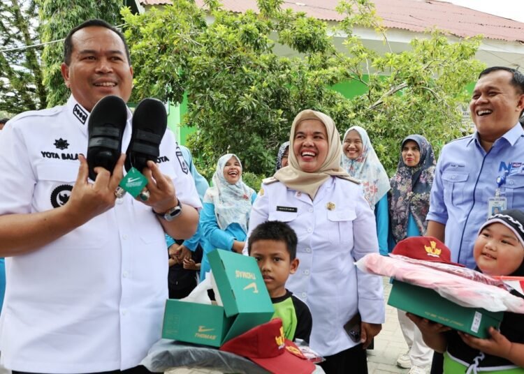 Wali Kota Pariaman Yota Balad menyerahkan seragam sekolah gratis bagi siswa kelas 1 Sekolah Dasar, Rabu (20/8/2025).