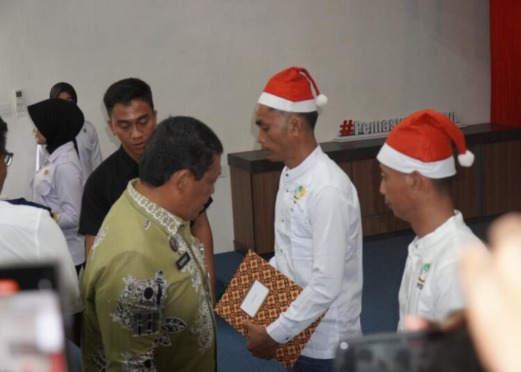 Kepala Kantor Wilayah Ditjen Pemasyarakatan Sumbar, Kunrat Kasmiri, menyerahkan dokumen remisi kepada narapidana penerima khusus Natal di Lapas Kelas IIA Padang pada Kamis (25/12). Foto: Kantor Wilayah Ditjen Pemasyarakatan Sumbar