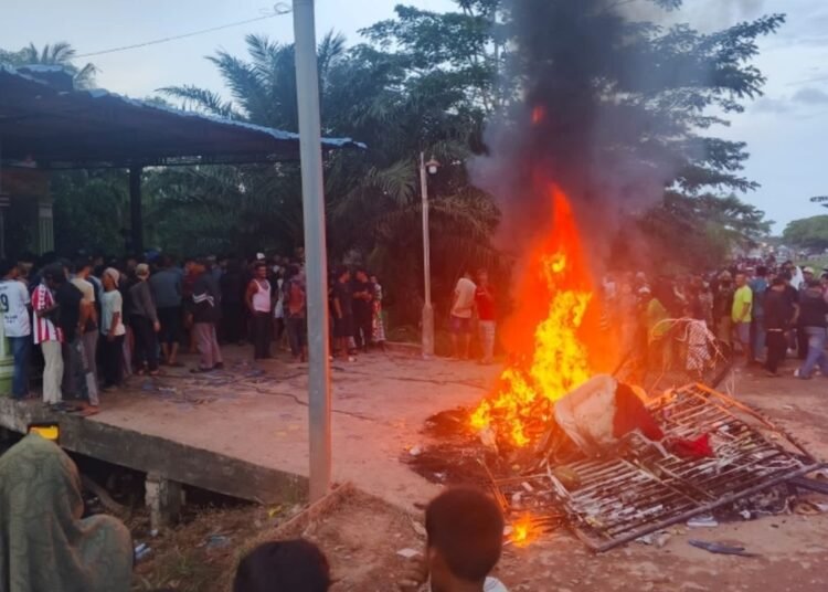 Warga membakar sepeda motor diduga milik pengedar narkoba di Kabupaten Rokan Hilir, Riau, Jumat (10/4/2026). Foto: Polda Riau