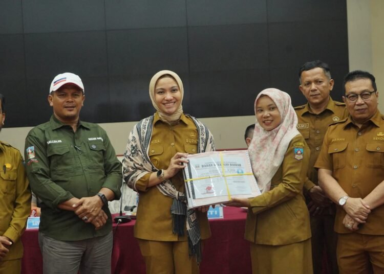 Bupati Dharmasraya Annisa Suci Ramadhani menyerahkan secara simbolis Daftar Himpunan Ketetapan Pajak (DHKP) dan Surat Pemberitahuan Pajak Terutang Pajak Bumi dan Bangunan Perdesaan dan Perkotaan (SPPT PBB-P2) tahun 2026 kepada wali nagari.